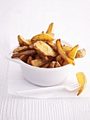 A plastic bowl of country potato wedges