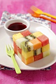 A fruit cube made of melon, kiwi and pineapple