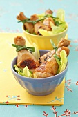 Chicken legs on a mixed leaf salad