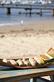 Spring rolls with mango on the beach