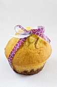 A chocolate and vanilla muffin tied with a bow
