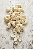Cashew nuts on a white wooden surface