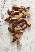 Pecan nuts on a white wooden surface