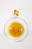 Vegetables in beef stock in the shape of a face