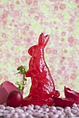 A sugar Easter bunny, radishes and coloured egg shells