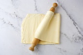 Puff pastry being folded and rolled