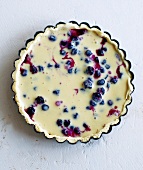 An unbaked blueberry tart