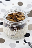 A jar of rice and dried mushrooms
