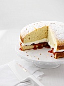 Sponge cake with cream and strawberry jam, sliced