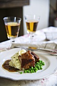 Ale-braised pork with mashed potatoes and peas