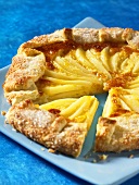 Pair and almond galette on a blue plate