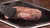 Grilling beefsteak on an electric grill