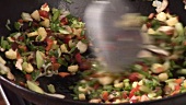 Stir-frying vegetables in a wok