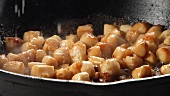 Lemon juice being added to fried scallops