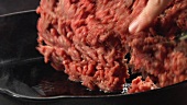 Minced meat being fried in a hot pan