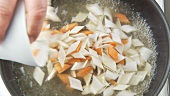 Vegetable pieces being cooked in salt water