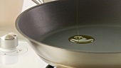 Olive oil being heated in a non-stick pan