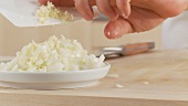 Garlic being added to finely chopped onion