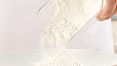 Flour being poured onto a plate