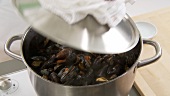 Cooked mussels being stirred