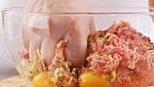 Minced meat being mixed with other ingredients