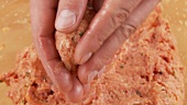 Burgers being shaped from minced meat dough