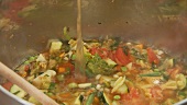 Vegetable stew being quenched with stock