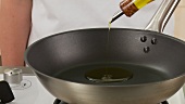 Olive oil being heated in a pan