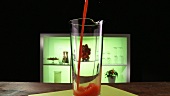 Tomato juice being poured into a glass