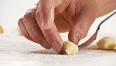 Gnocci being rolled over a fork