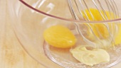 Ingredients for mayonnaise being mixed with a whisk