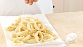 Fried squid rings being prepared (US-English Voice Over)