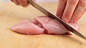 Chicken breast being sliced