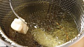 Fish fillets being placed in a frying basket