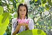 Young woman holding a water lily