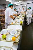 Preparing trays of food in canteen kitchen