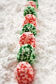Red and green Christmas bonbons in icing sugar