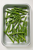 Fresh green asparagus in a roasting tin