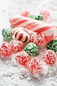 Christmas bonbons and candy canes in icing sugar