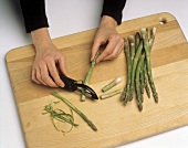 Peeling Fresh Asparagus on Cutting Board