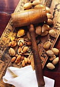 Whole and Shelled Almonds with a Wooden Hammer Nut Cracker