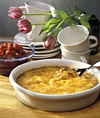 Creme Brulee in a Dish with a Spoon Scooping