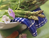 Close Up of Asparagus in a Bowl with Pansies