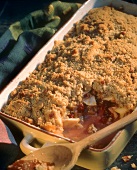 Apple Cherry Crisp in a Pan with Piece Missing