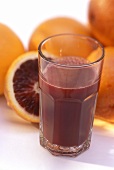 A Glass of Blood Orange Juice with Blood Oranges