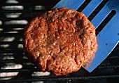 Turning a Hamburger on the Grill with Spatula