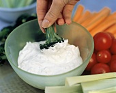 Dipping Broccoli into Vegetable Dip