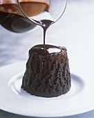 Pouring Chocolate Sauce over Chocolate Pudding