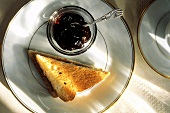 Slice of Toast Cut in Half with Bowl of Jam