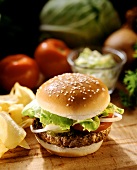 Hamburger with Lettuce Onions and Tomato on a Sesame Seed Bun